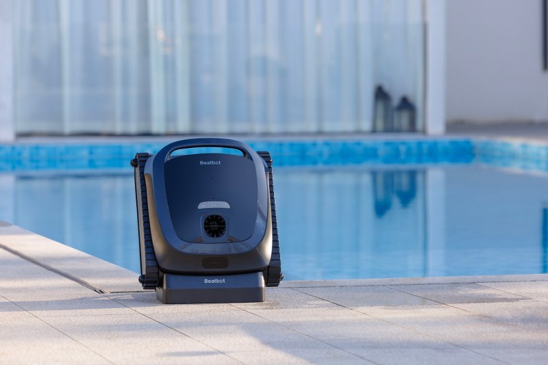 The Beatbot Aquasense 2 robotic pool cleaner beside the swimming pool.