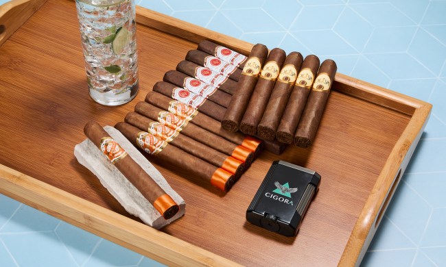 Cigora setup with cigars, cocktail, and lighter