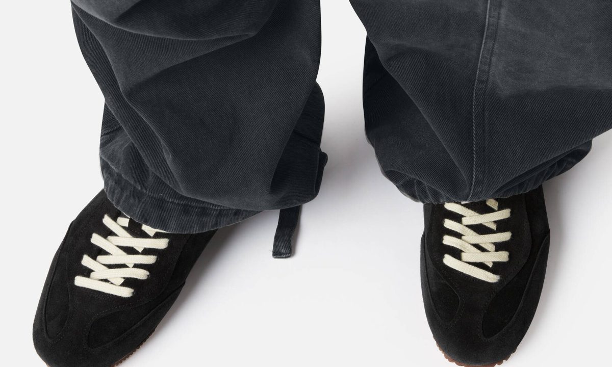 model wearing black axel arigato sneakers