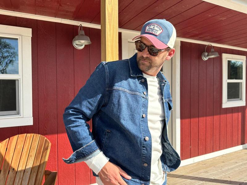 Man in denim jacket and hat