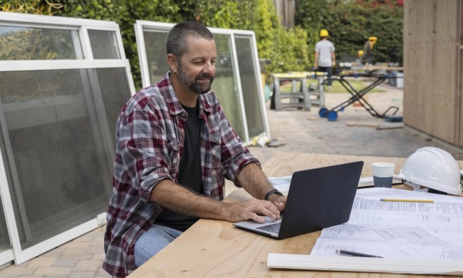 guy on laptop at job site