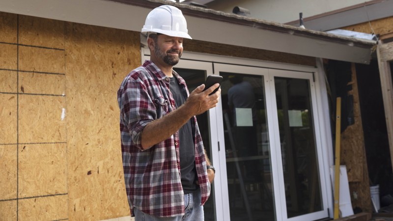 guy on jobsite in a hard hat and on the phone