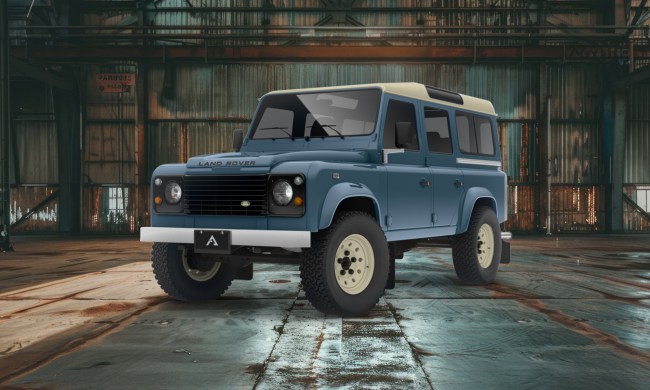 Marine blue Arkonik Heritage Works 110 parked in an empty warehouse left front three-quarter view.