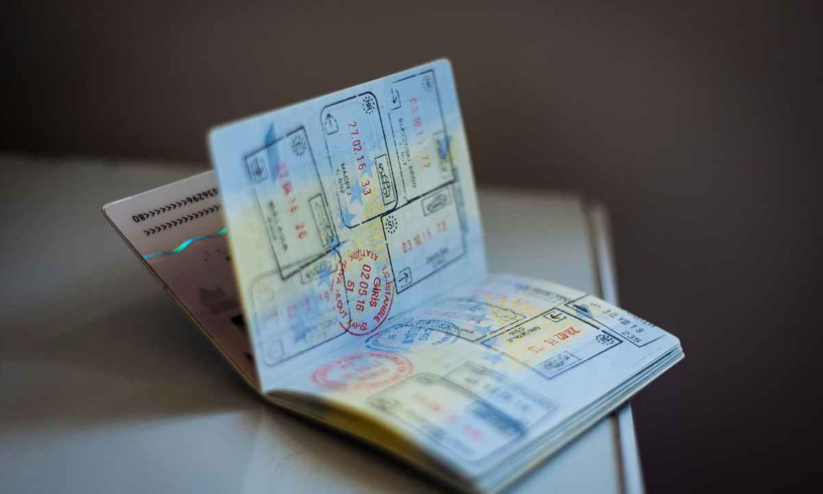 passport book on table open with stamps