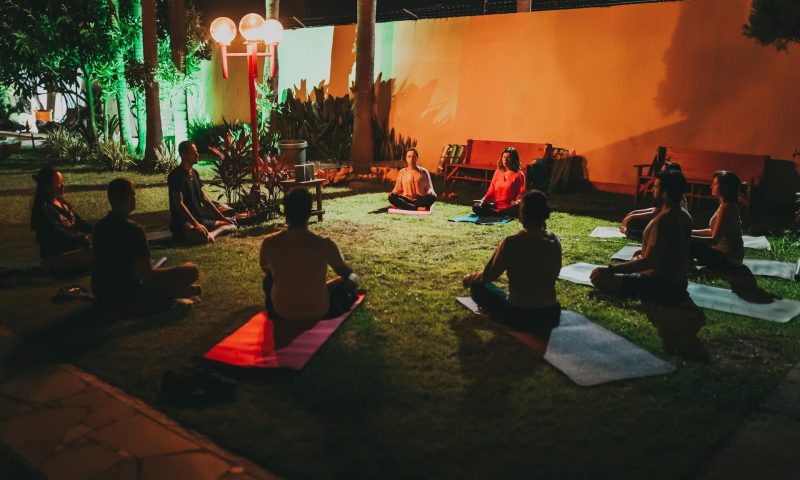 people doing yoga class outside in circle