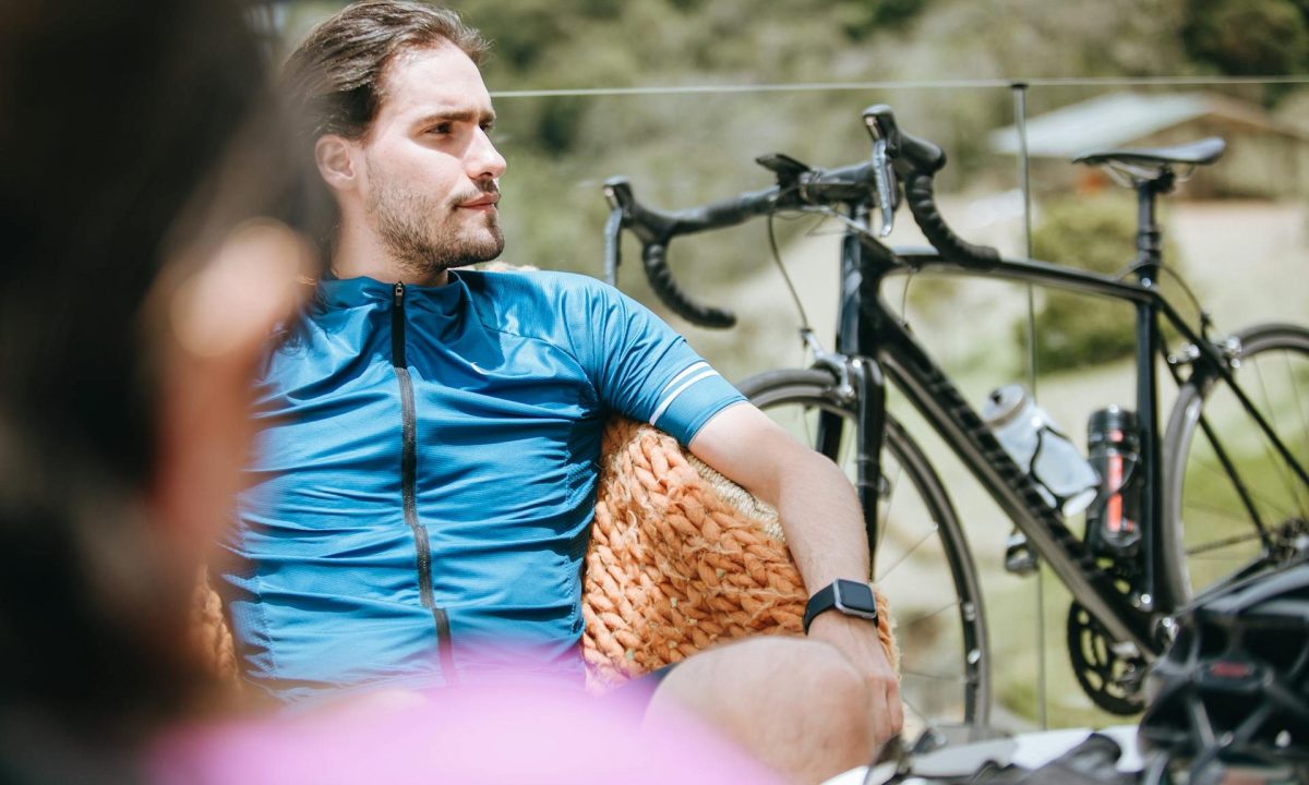 man sitting near bicycle