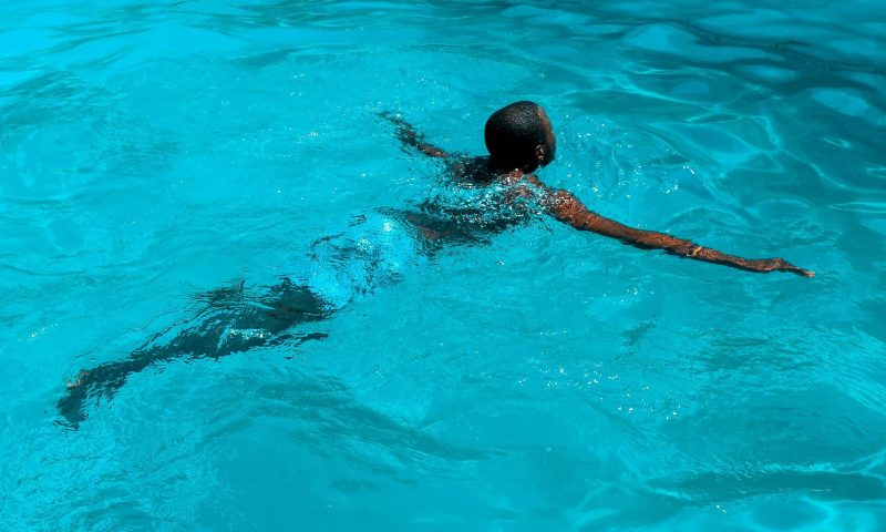 man exercising swimming in pool