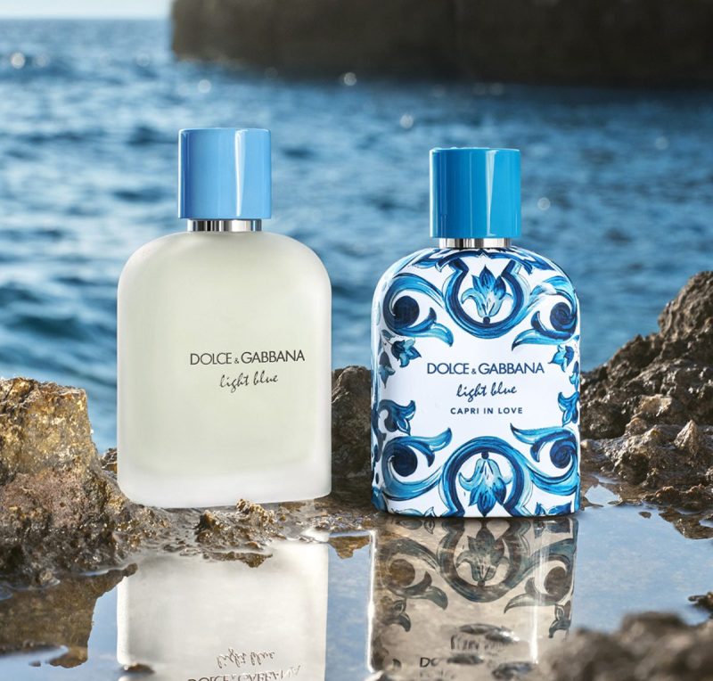 bottles of light blue fragrances on rocky shore