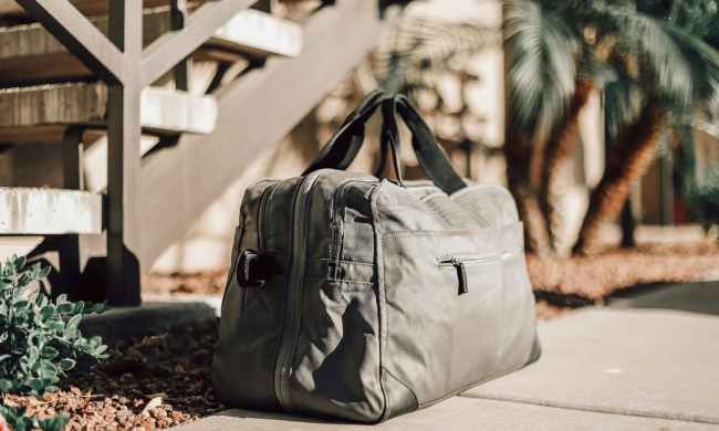 weekender bag sitting on the ground