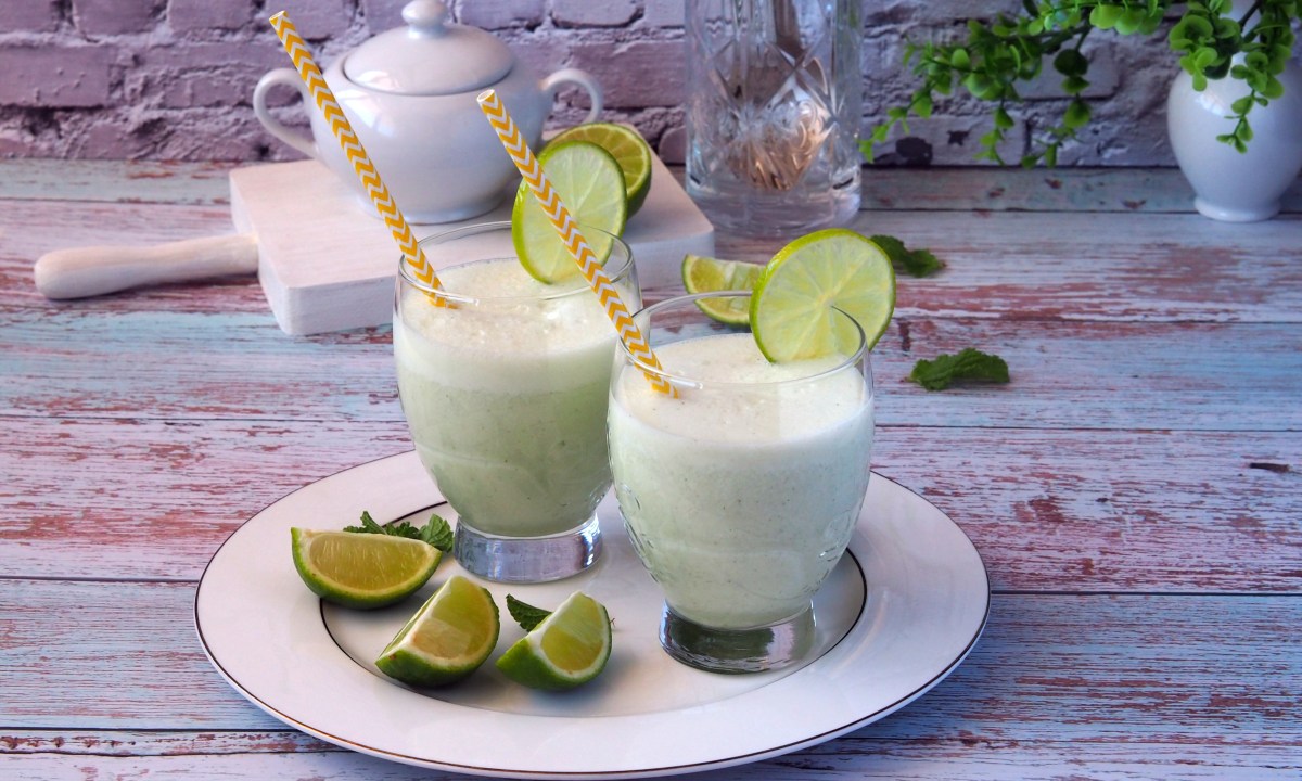 lemonade with condensed milk and lime. Two glasses with a drink, served with citrus slices and mint