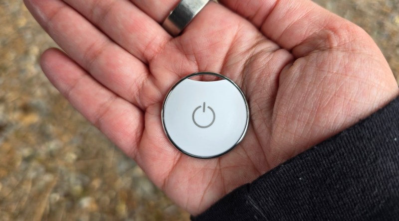 Aster Button in the palm of a hand