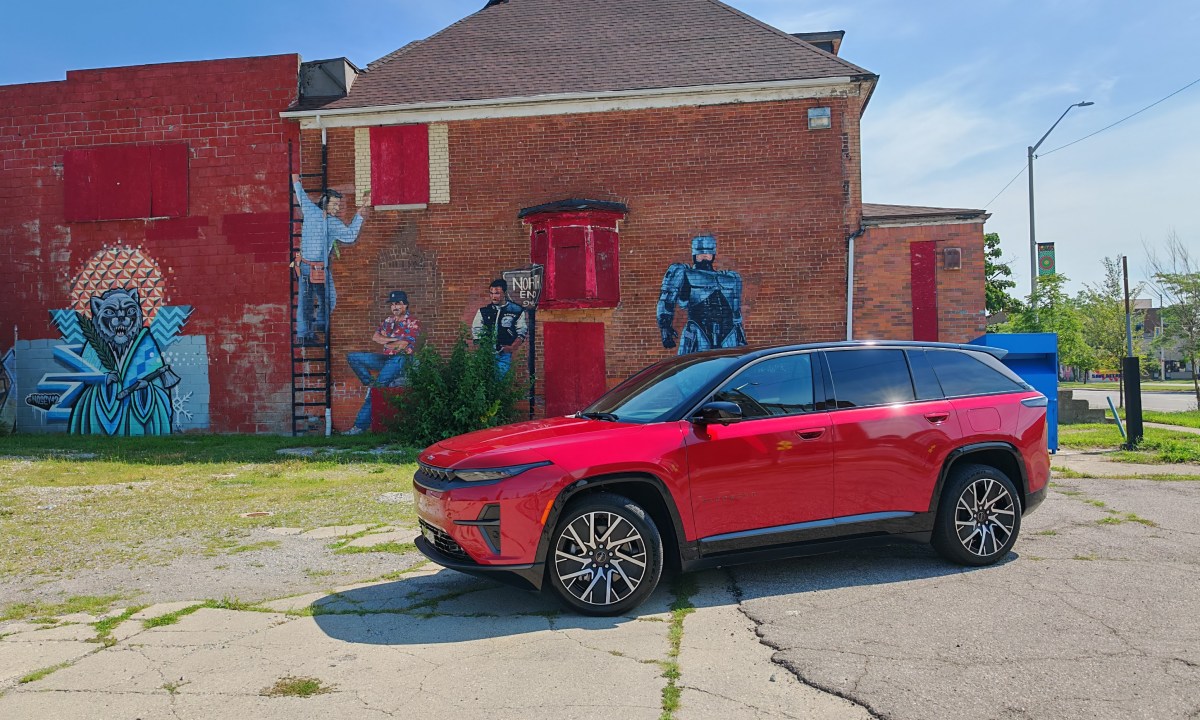 Front 3/4 view of the Jeep Wagoneer S in front of a Robocop mural in downtown Detroit