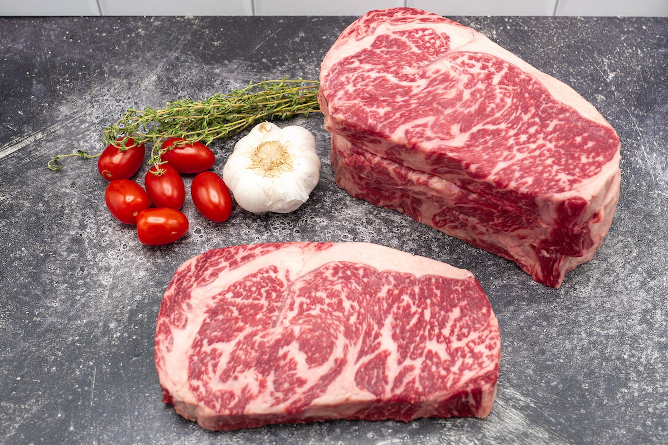 Two Mishima ribeye steaks on counter