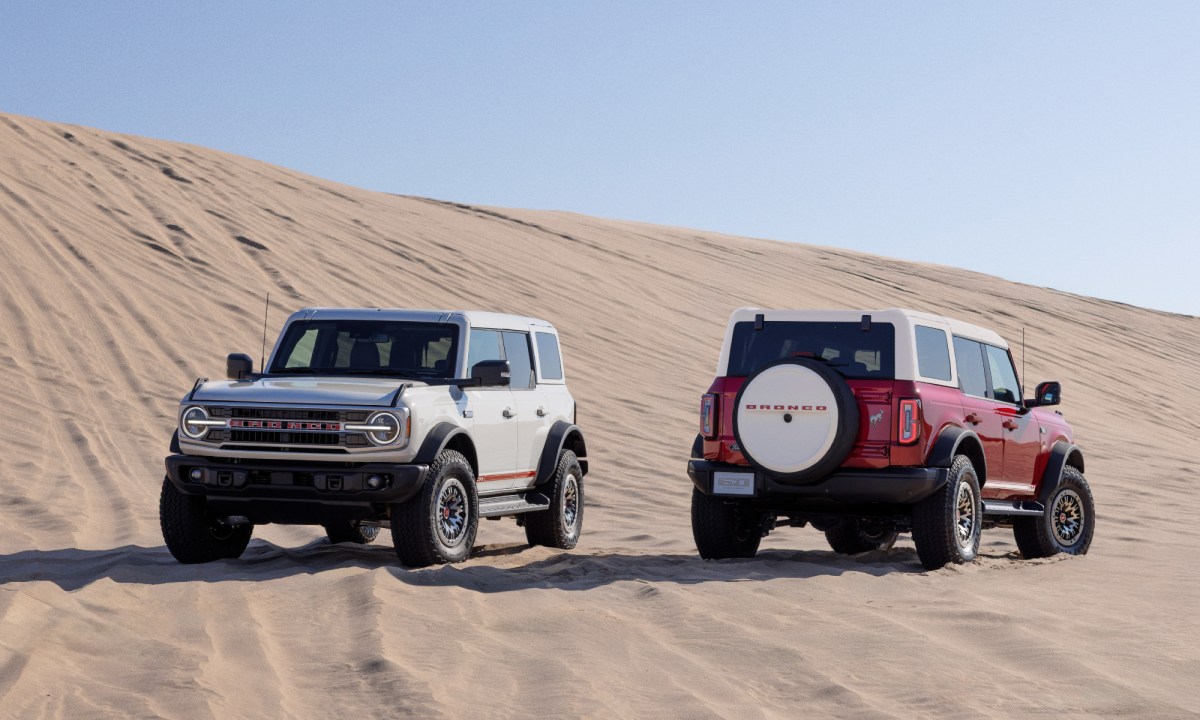 Two 2026 Ford Bronco 60th Anniversary Package SUVs parked on desert sand.