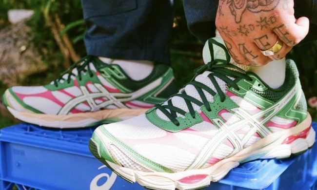 person wearing asics on top of crate