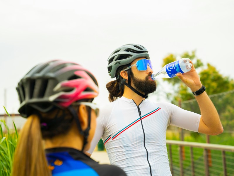 Biker drinking water and electrolytes.