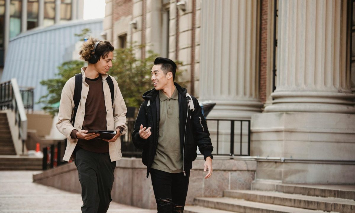 two men walking around the block