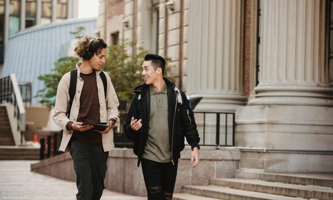 two men walking around the block
