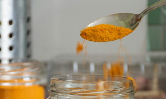 turmeric spice powder spoon jar