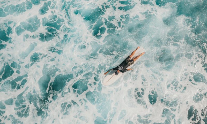man paddling surfing