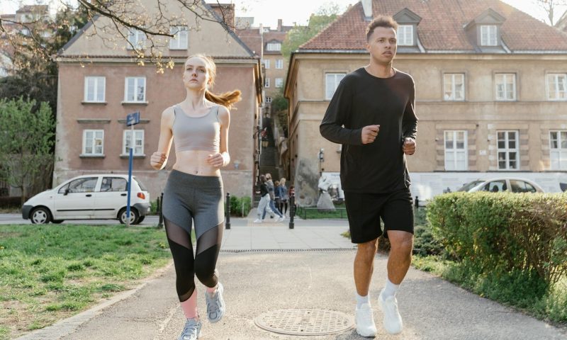 people man and woman running in city outdoors