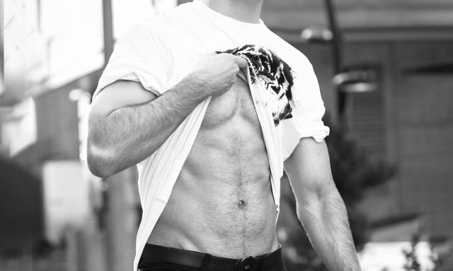 man lifting shirt abs
