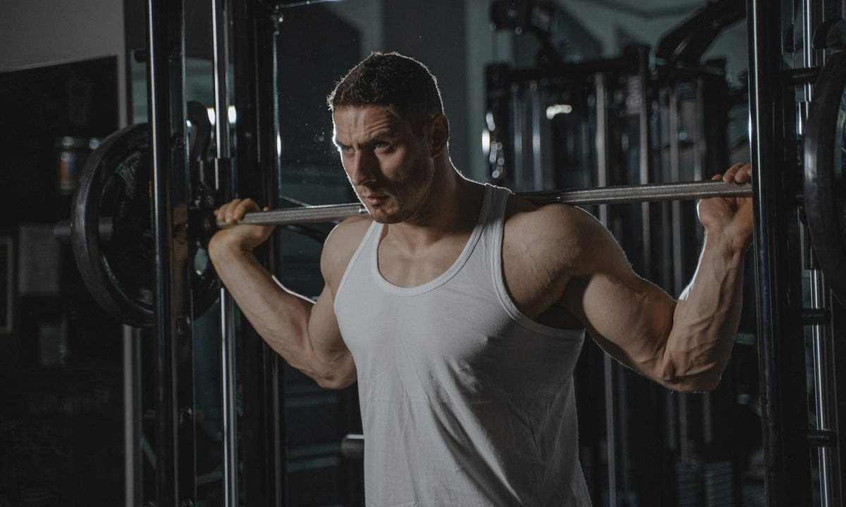 man with barbell squat weightlifting resistance training
