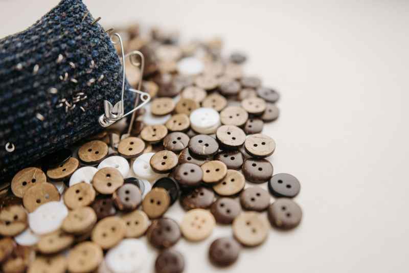 wooden buttons and safety pins on table