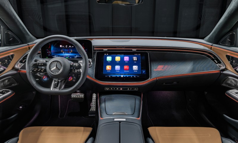 2026 Mercedes AMG E 53 Hybrid wagon cockpit view of the front seats, dashboard, and console.