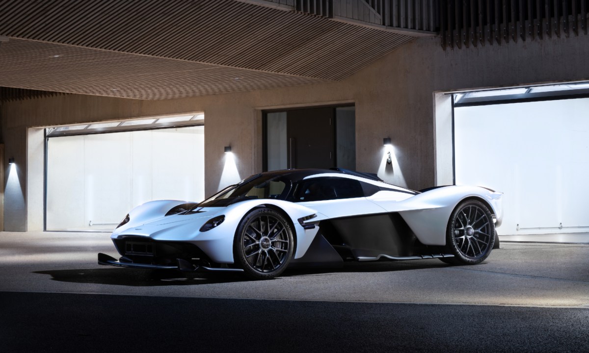 Daniel Ricciardo Aston Martin Valkyrie left front three quarter view parked in front of a garage door.