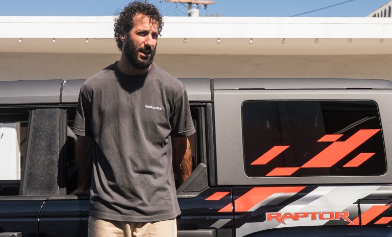 Daniel Ricciardo standing next to a Ford Bronco Raptor.