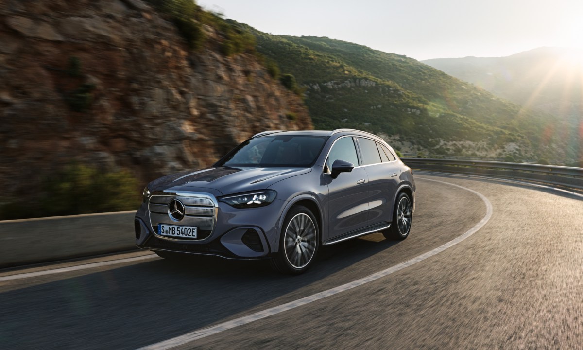 Mercedes-Benz GLS all-electric SUV left front three quarter view on a mountainside road.