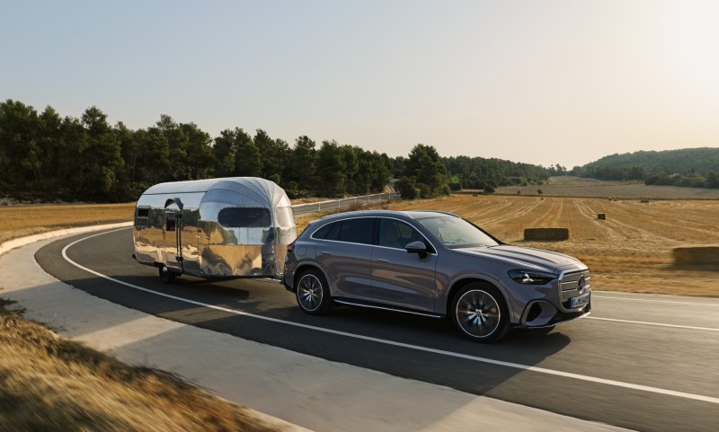Mercedes-Benz GLS all-electric SUV right front three quarter view pulling an RV trailer.