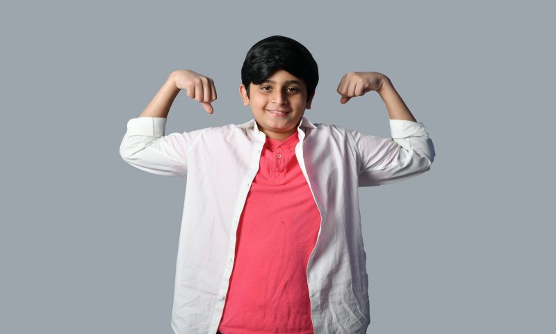 kid flexing muscles