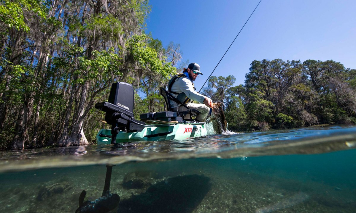Young angler in a fishing kayak with Garmin's Force Current wireless propulsion system installed.