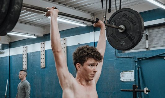 kid teen lifting barbell