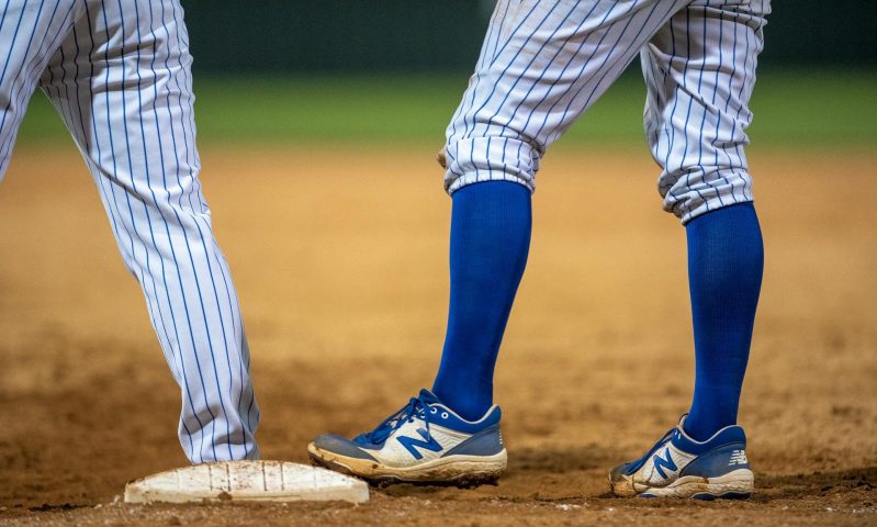 man playing baseball wearing compression socks