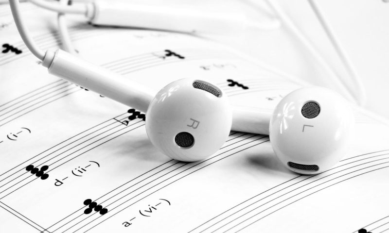headphones on music theory notes