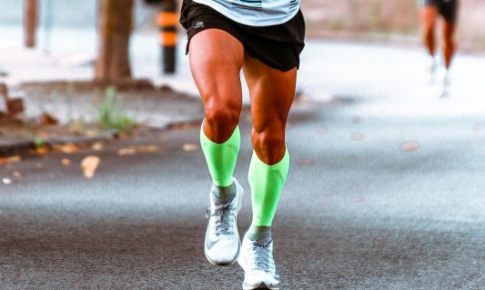 man running wearing compression socks