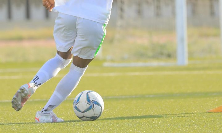 man wearing compression socks playing football