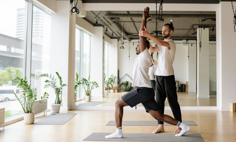 pexels-yankrukov-men exercising yoga stretching