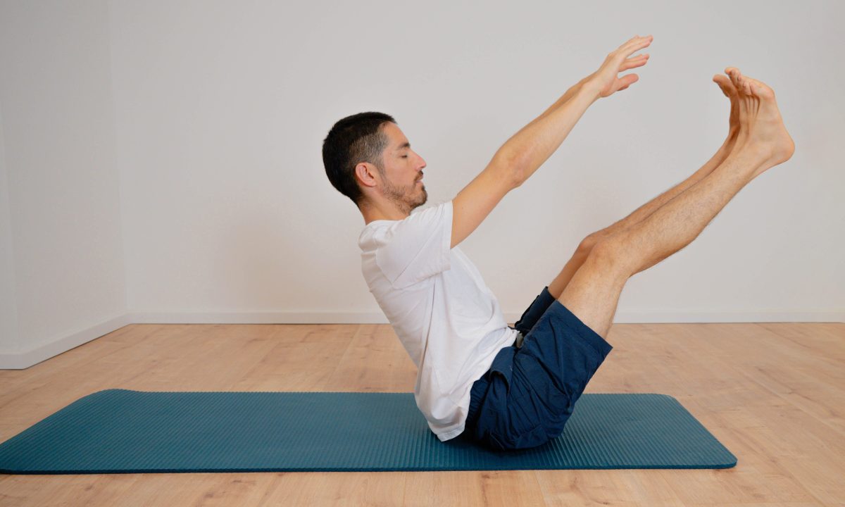man doing boat pose